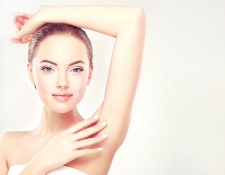 Armpit epilation, lacer hair removal. Young woman holding her arms up and showing underarms, armpit smooth clear skin .Girl showing clean armpit .Beauty portrait.Epilation and depilation of hair .